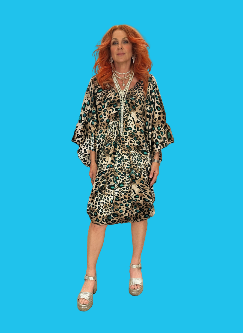 Woman wearing a leopard print dress on a blue background