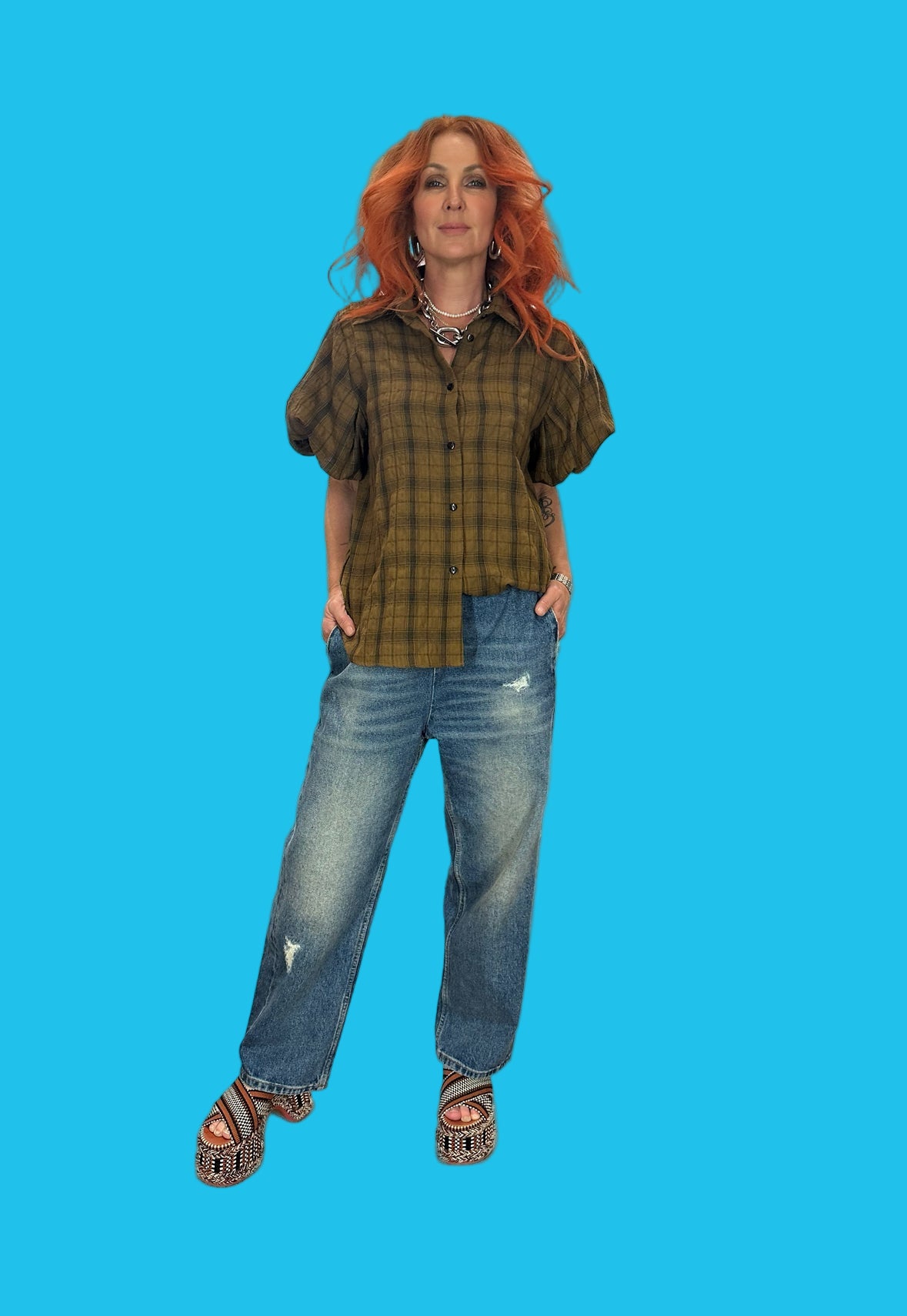 Person wearing a plaid shirt and jeans on a blue background