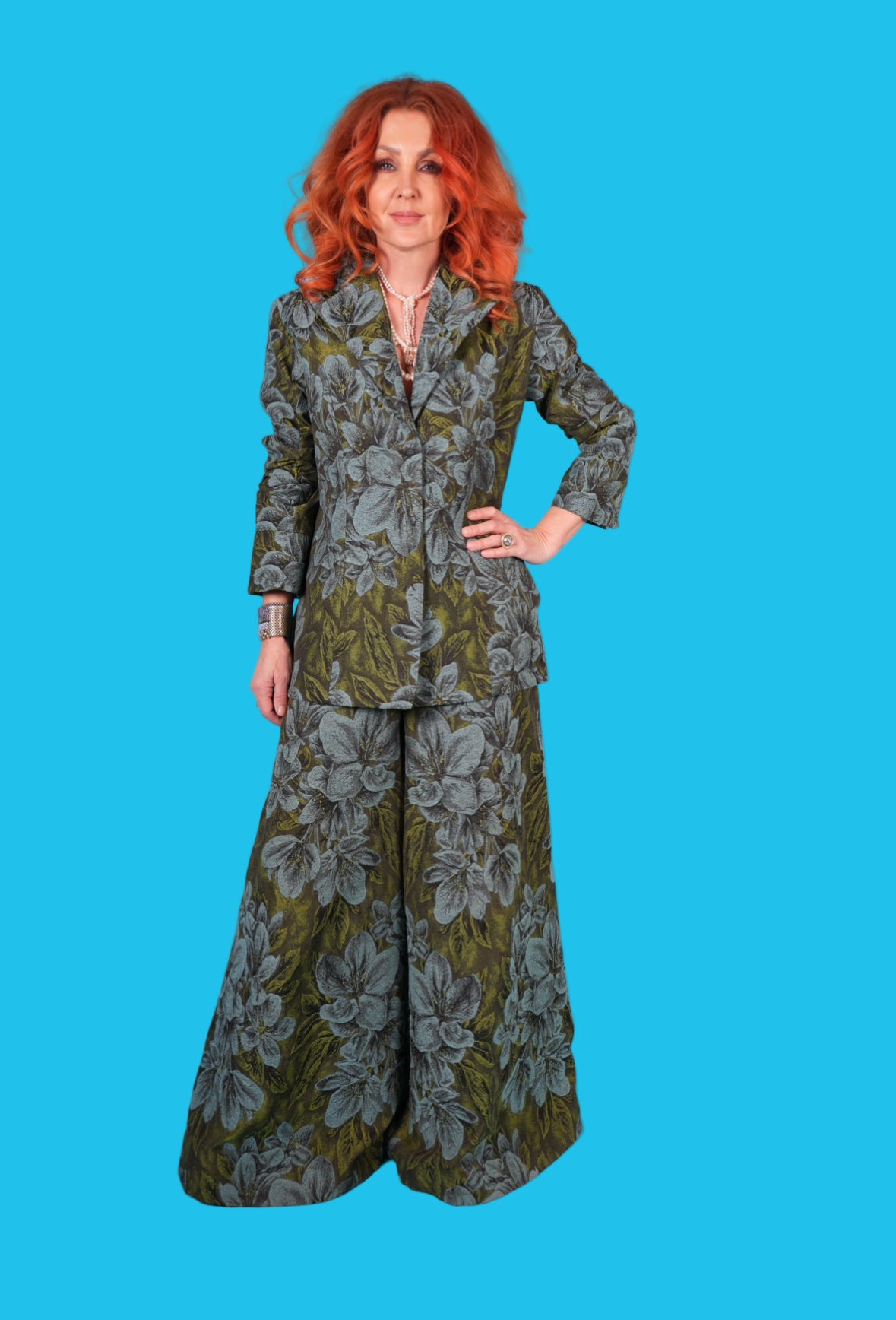 Woman wearing a floral patterned outfit on a blue background