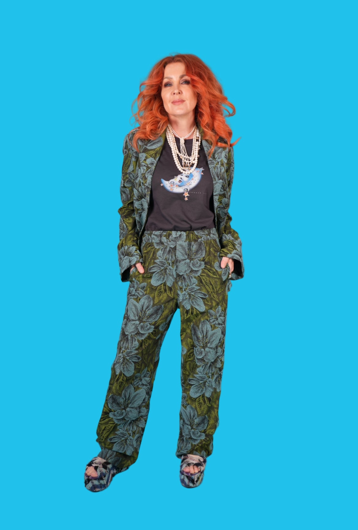 Woman wearing a floral suit with a blue background