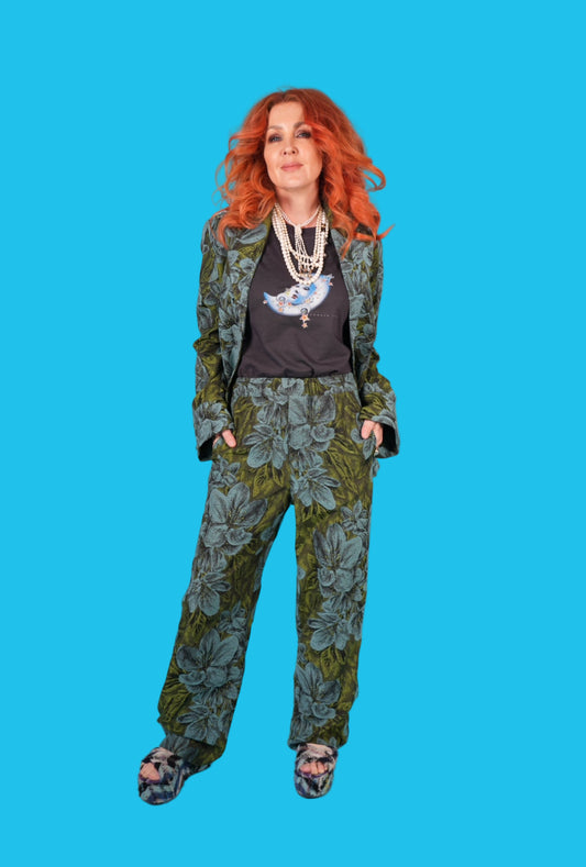 Woman wearing a floral suit with a blue background